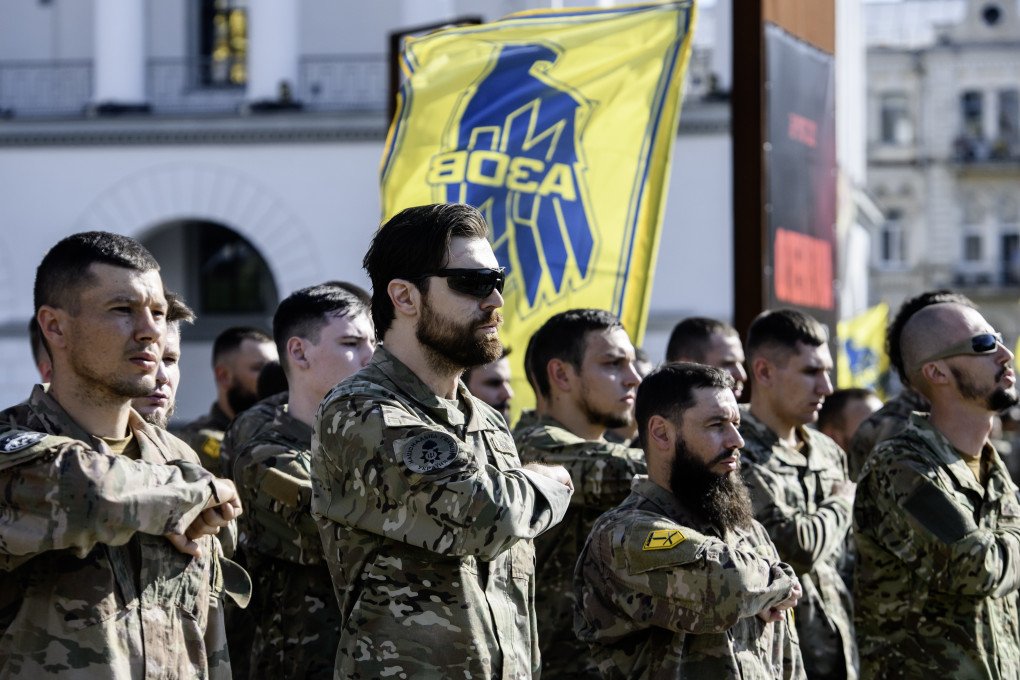 Servicemen of the Azov battalion are attending a ceremony to remember the victims of the Olenivka camp explosion. (Photo by Maxym Marusenko via Getty Images)