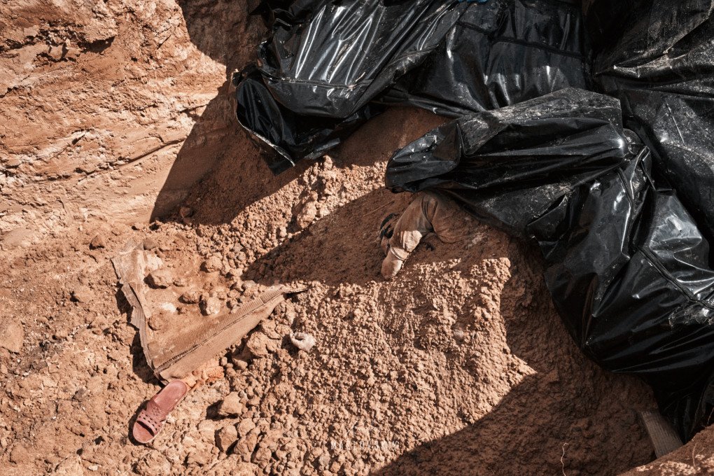 A child’s hand can be seen emerging from a mass grave of civilians killed by Russian forces in Bucha, Ukraine. (Ruslan Maslovskiy)