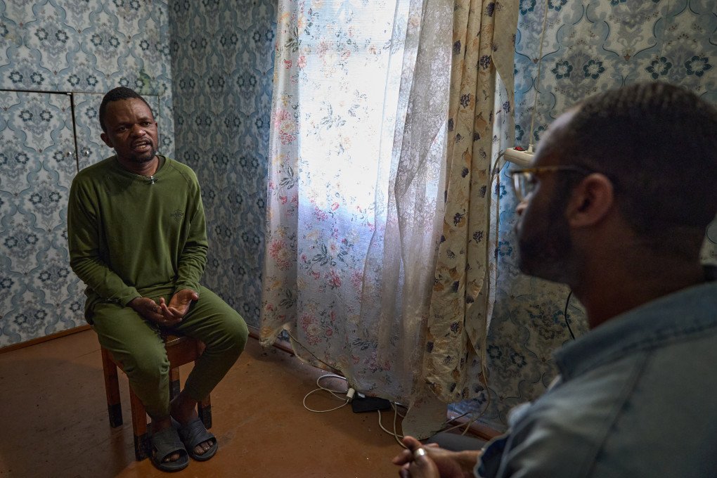 Zimbabwean prisoner of war Tatenda Tarwire speaks during an exclusive interview with a UNITED24 Media journalist. Tarwire is one of several foreign POWs captured by Ukraine who have spoken out about the deceptive tactics used by Moscow to recruit citizens from developing nations into the Russian military. (Photo: Mykyta Shandyba / UNITED24 Media) Zimbabwean prisoner of war (POW) Tatenda Tarwire speaks during an interview with a UNITED24 Media journalist, who is seated in the foreground of the room.