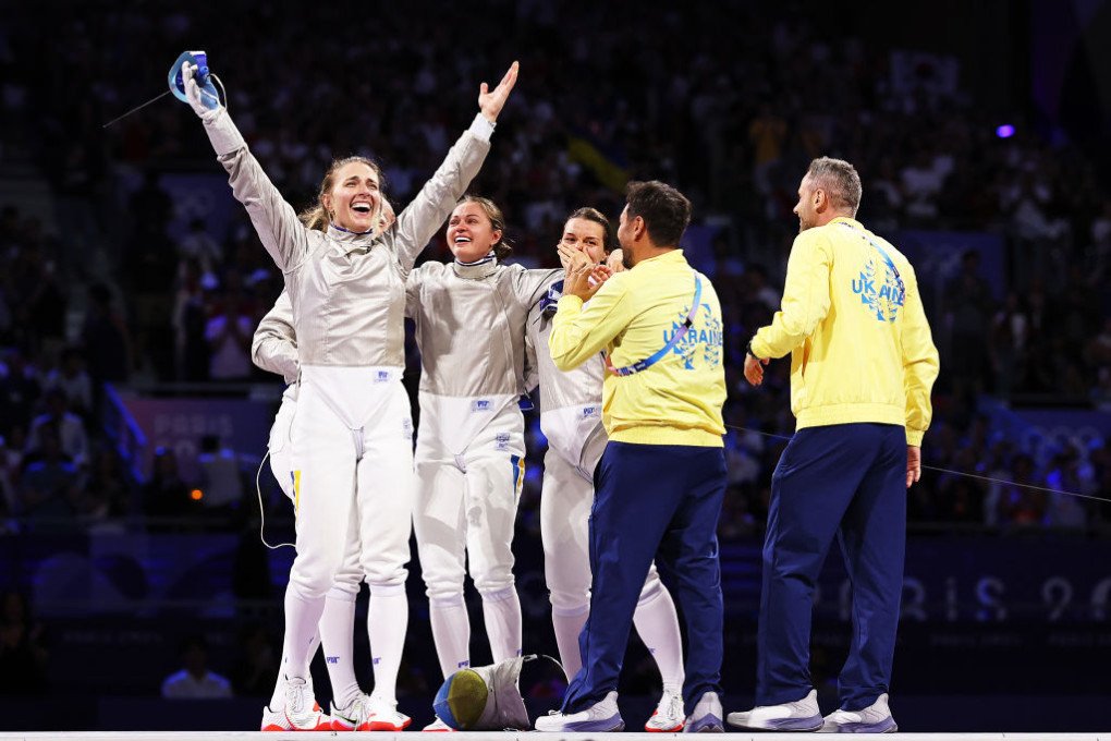 Olha Kharlan of Team Ukraine (L) celebrates with teammates following the team’s victory during the Fencing Women’s Sabre Team Gold Medal match on day eight of the Olympic Games Paris 2024 at Grand Palais on August 03, 2024 in Paris, France. (Source: Getty Images) Olha Kharlan of Team Ukraine (L) celebrates with teammates following the team’s victory during the Fencing Women’s Sabre Team Gold Medal match on day eight of the Olympic Games Paris 2024 at Grand Palais on August 03, 2024 in Paris, France. (Source: Getty Images)