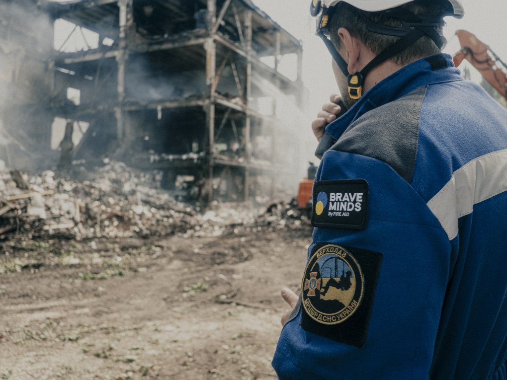 Rescuer looks over the remains of a building after a massive Russian attack in Kyiv. (Photo: Edward Matthews)