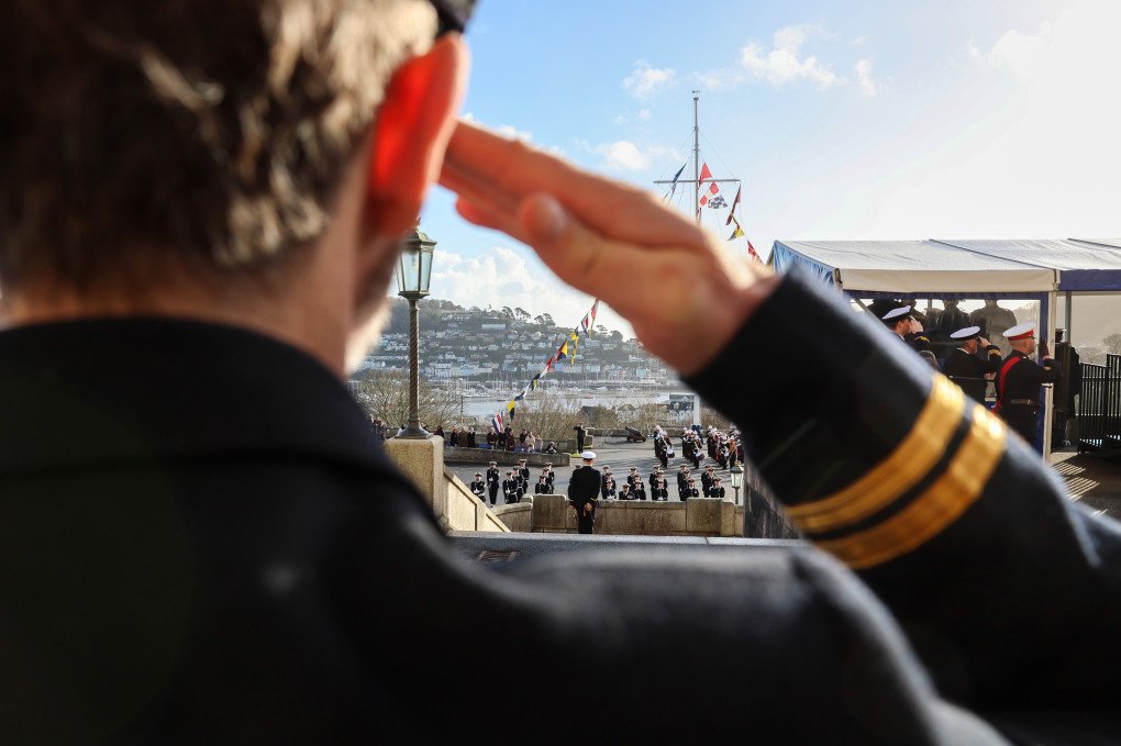 A newly commissioned Naval Officers salutes during the Lord High Admiral's Divisions at Britannia Royal Naval College on December 19, 2025 in Dartmouth, England. (Source: Chris Jackson via Getty Images) A newly commissioned Naval Officers salutes during the Lord High Admiral's Divisions at Britannia Royal Naval College on December 19, 2025 in Dartmouth, England. (Source: Chris Jackson via Getty Images)