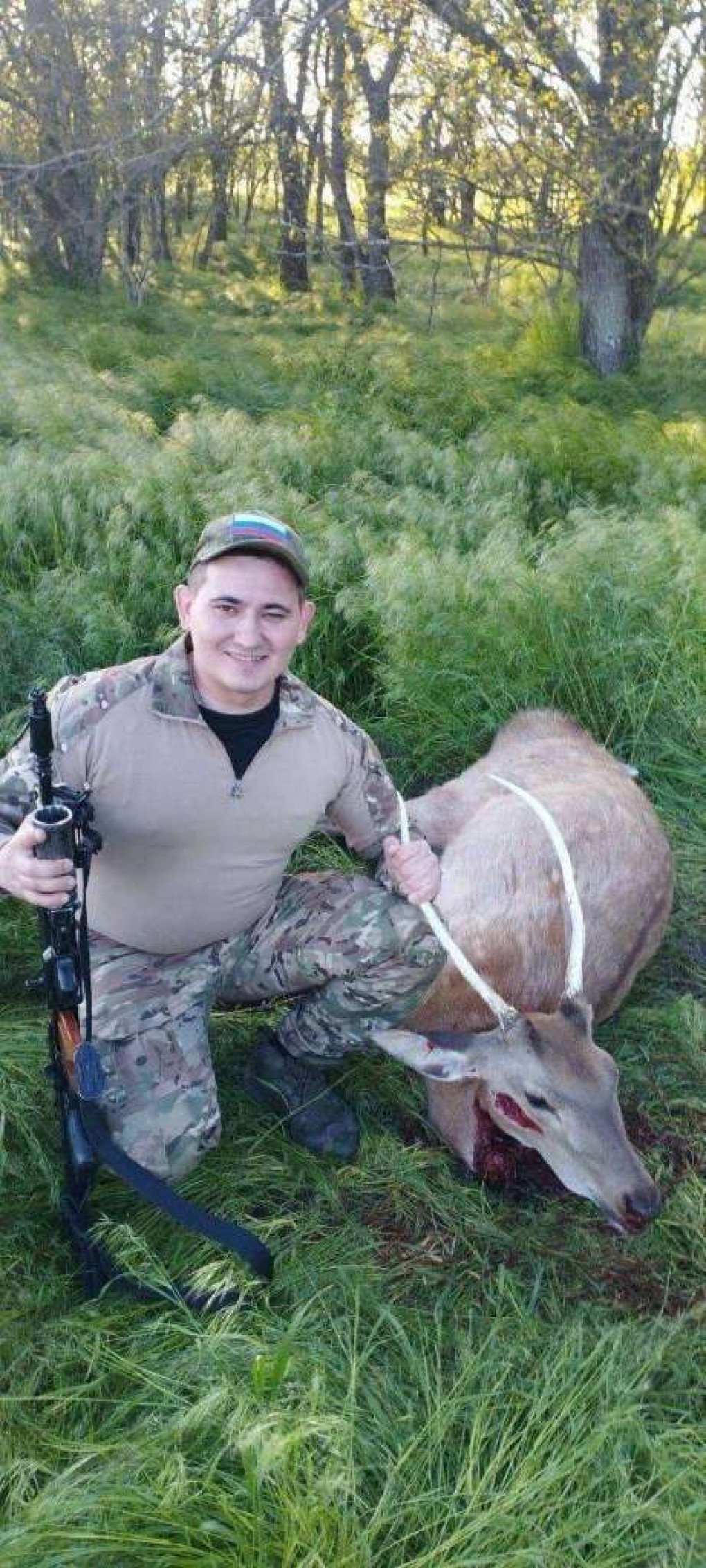 Russian soldier posing with a killed Red deer. (Source: UAnimals/ Facebook)