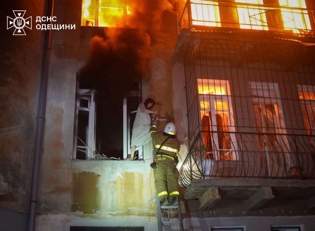 Rescuers evacuate a woman from a house that caught fire after a Russian drone attack on Odesa on June 20, 2025. (Source: SES)
