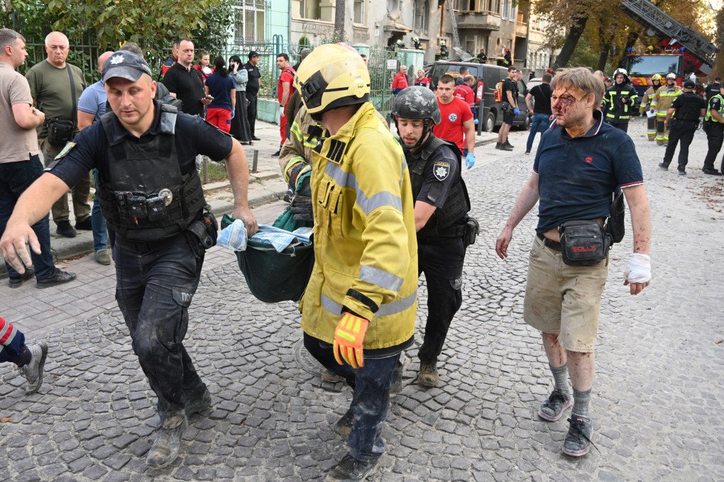 Injured local resident Yaroslav Bazylevych (R) follows Ukrainian rescuers carrying the body of his daughter, who was killed along with her two sisters and their mother during a missile attack in Lviv on September 4, 2024. (Photo by YURIY DYACHYSHYN/AFP via Getty Images) Injured local resident Yaroslav Bazylevych (R) follows Ukrainian rescuers carrying the body of his daughter, who was killed along with her two sisters and their mother during a missile attack in Lviv on September 4, 2024. (Photo by YURIY DYACHYSHYN/AFP via Getty Images)