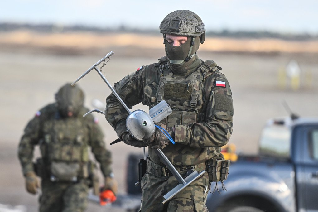 A Polish soldier carries a Merops drone during a NATO counter-drone exercise in Nowa Deba, Poland, November 18, 2025. (Source: Getty Images)