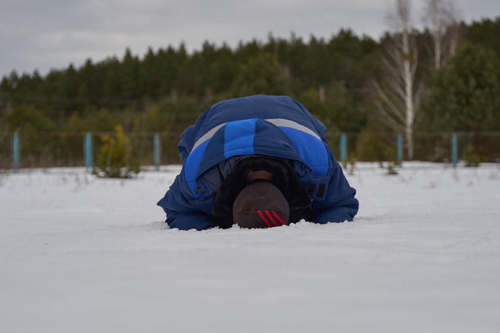 One of the freed defenders opens his arms to the sky then kneels to the ground multiple times. He said he was waiting to return to Ukraine to kneel on its soil. March 6, 2026, undisclosed location, Ukraine. Photo by Mykyta Shandyba, UNITED24 Media