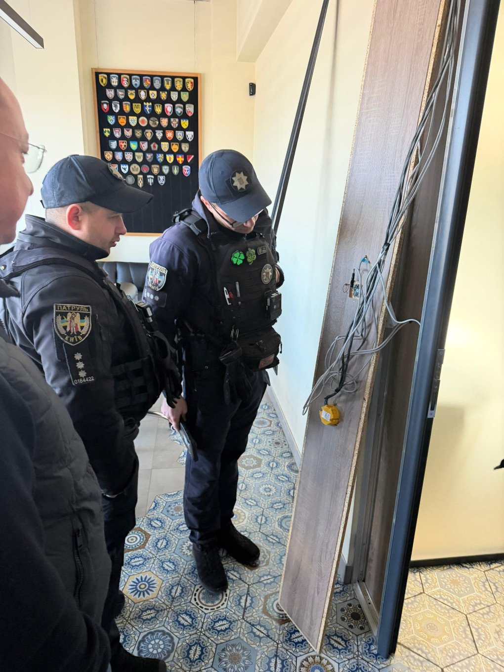 Police officers looking at a Russian spy device found in the office of the Ukrainian drone manufacturer, March 24, 2026.
