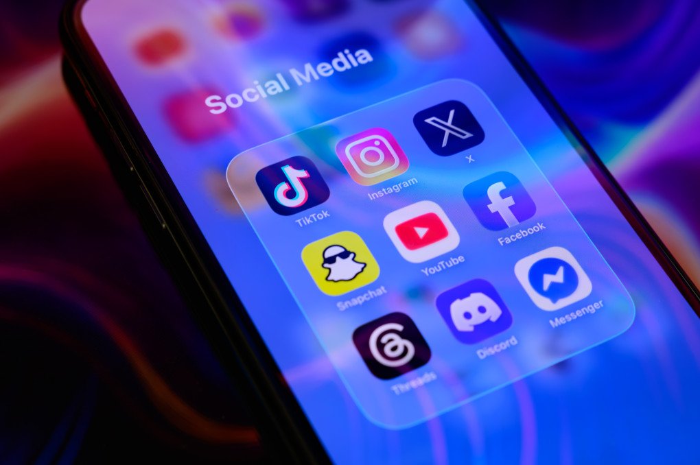 A folder of social media applications, including TikTok, Instagram, X (formerly Twitter), Snapchat, YouTube, Facebook, Threads, Discord, and Messenger. (Photo by Samuel Boivin via Getty Images)