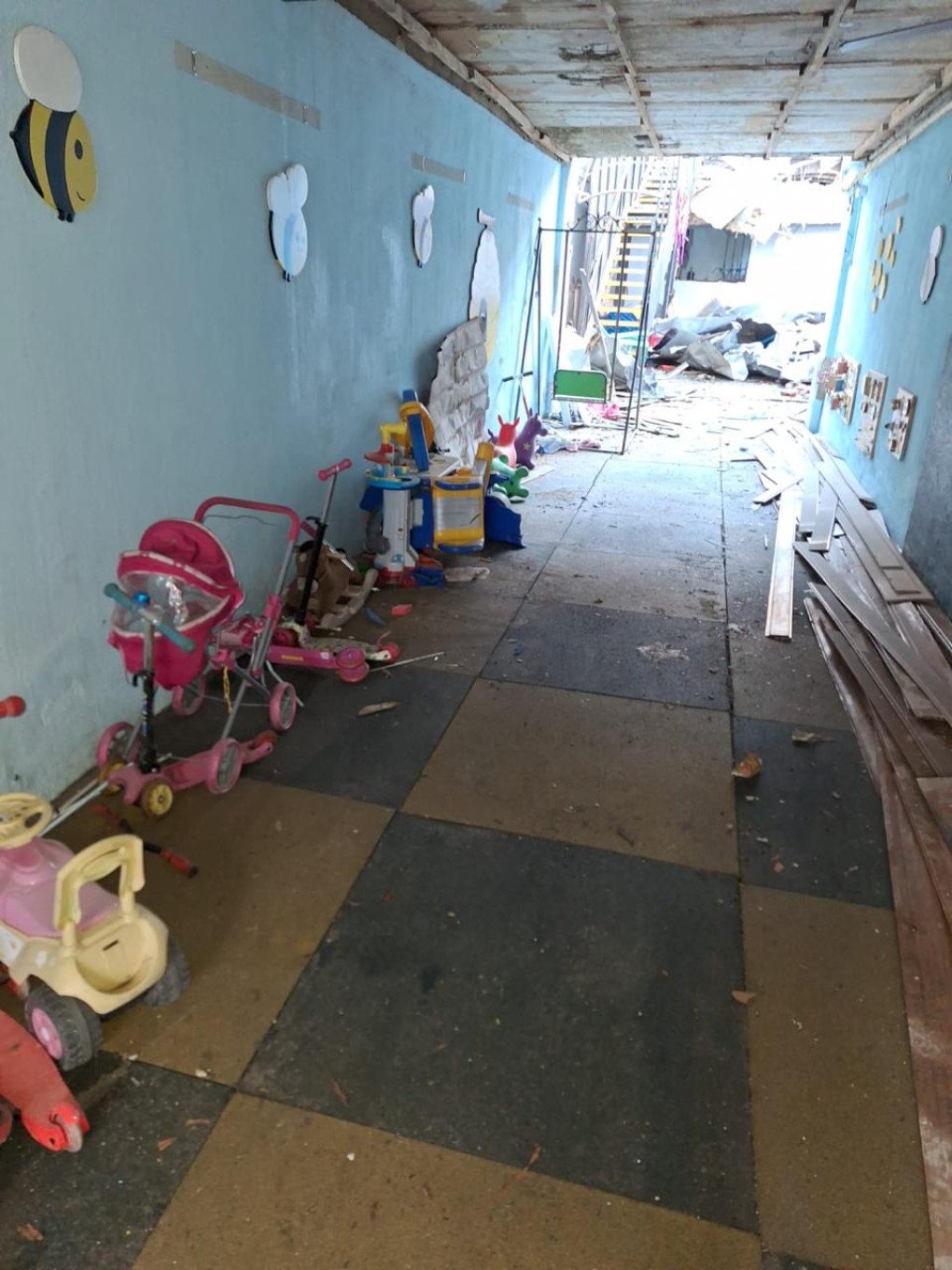 A corridor lined with children’s toys and strollers shows signs of heavy destruction after the attack. (Source: SBU)