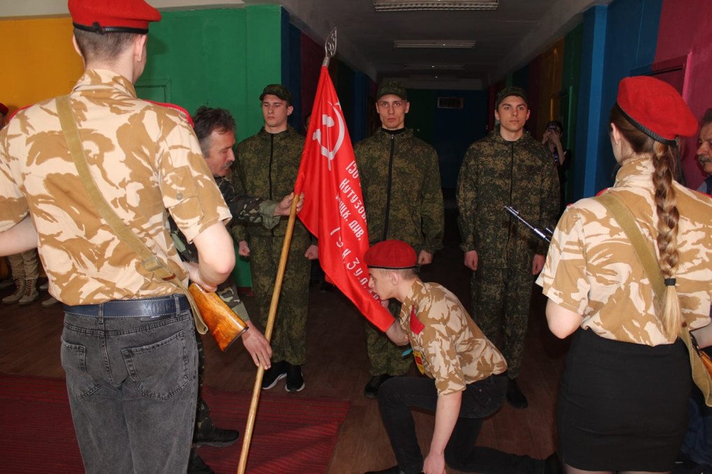 Member of the Youth Army is kissing the Victory Banner, the banner raised by Red Army soldiers on the Reichstag building in Berlin on 1 May 1945, kneeling on one knee. (Source: Head of the Board of the Ukrainian Human Rights Protection Center Liudmyla Denisova/Facebook) Member of the Youth Army is kissing the Victory Banner, the banner raised by Red Army soldiers on the Reichstag building in Berlin on 1 May 1945, kneeling on one knee. (Source: Head of the Board of the Ukrainian Human Rights Protection Center Liudmyla Denisova/Facebook)