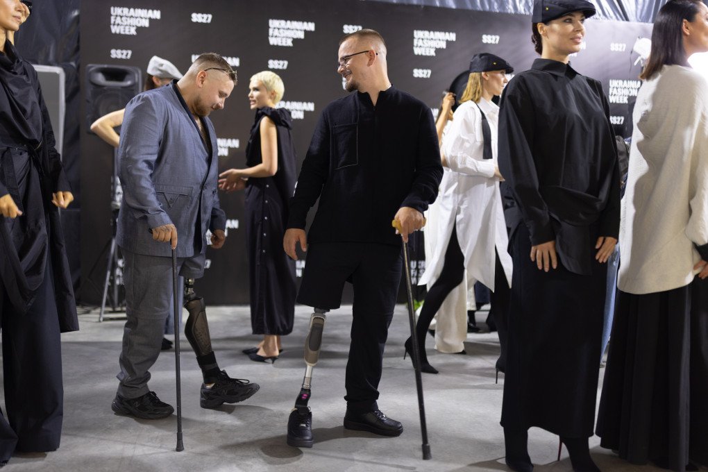 Two Ukrainian veterans wearing looks from JULIYA KROS’ SS2027 RECONSTRUCTION collection backstage at Ukrainian Fashion Week in Kyiv on September 4, 2026. (Source: Vic Bakin/UNITED24 Media)