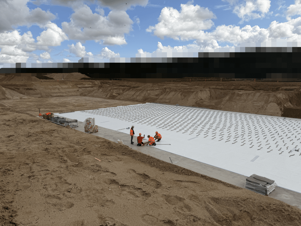 Construction workers laying down foundation of a future factory. (Photo: Zhenia Melnyk/UNITED24 Media)