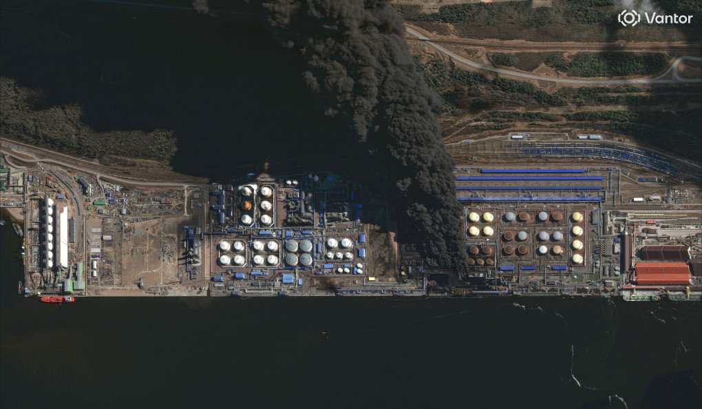 Satellite image shows multiple oil storage tanks on fire at the Ust-Luga oil terminal with thick dark smoke billowing eastward. (Satellite image: Vantor)