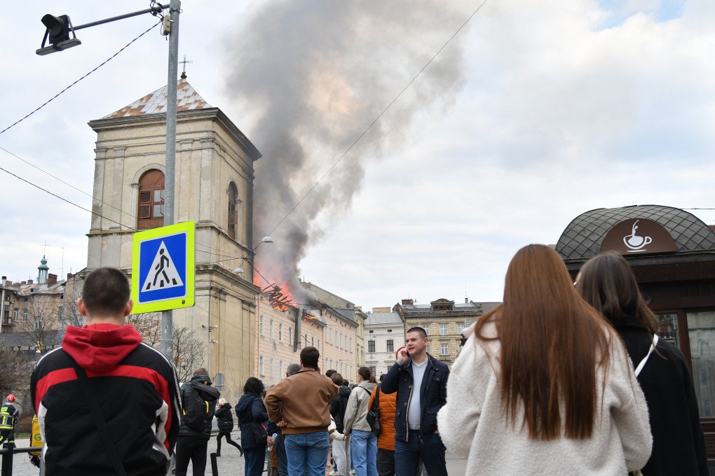 Firefighters extinguish a fire on building in center of city after Russian drone attack on March 24, 2026 in Lviv, Ukraine. (Source: Getty Images)