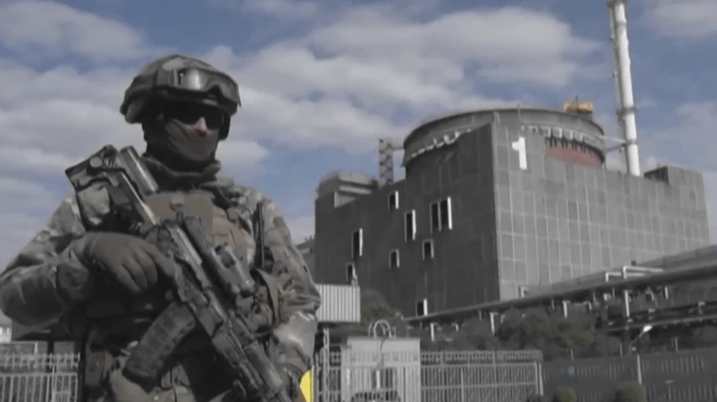 An armed Russian serviceman stands outside reactor unit 1 at the occupied Zaporizhzhia Nuclear Power Plant. (Source: UNITED24 Media/YouTube)