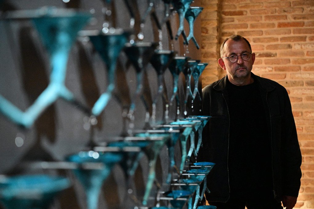 Ukrainian artist Pavlo Makov poses by his piece 'Fountain of Exhaustion' at Ukraine's pavilion during a press day at the 59th Venice Art Biennale in Venice on April 19, 2022. Photo by VINCENZO PINTO/AFP via Getty Images