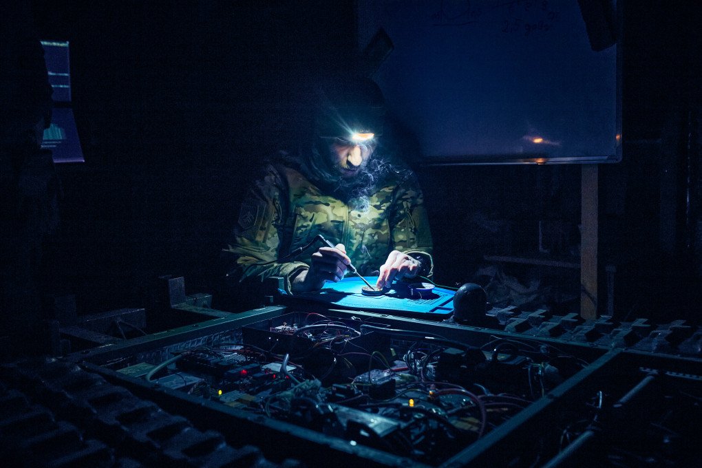 Platoon technical specialist soldering a repaired component back into a UGV. Photo: Alina Andreeva.