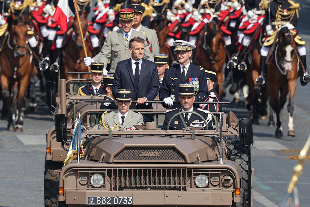 France’s President Emmanuel Macron and General Chief of Staff of the French Armed Forces Fabien Mandon review troops in the command car during the annual Bastille Day military parade on the Champs-Élysées Avenue in Paris on July 14, 2026. (Source: Getty Images) France’s President Emmanuel Macron and General Chief of Staff of the French Armed Forces Fabien Mandon review troops in the command car during the annual Bastille Day military parade on the Champs-Élysées Avenue in Paris on July 14, 2026. (Source: Getty Images)