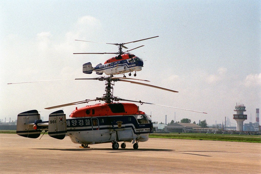 One Kamov Ka-32 Republic of Korea Maritime Police helicopter sits grounded at Pohang Airfield while another Republic of Korea Maritime Police helicopter hovers above it in the background. (Source: Wikimedia) One Kamov Ka-32 Republic of Korea Maritime Police helicopter sits grounded at Pohang Airfield while another Republic of Korea Maritime Police helicopter hovers above it in the background.