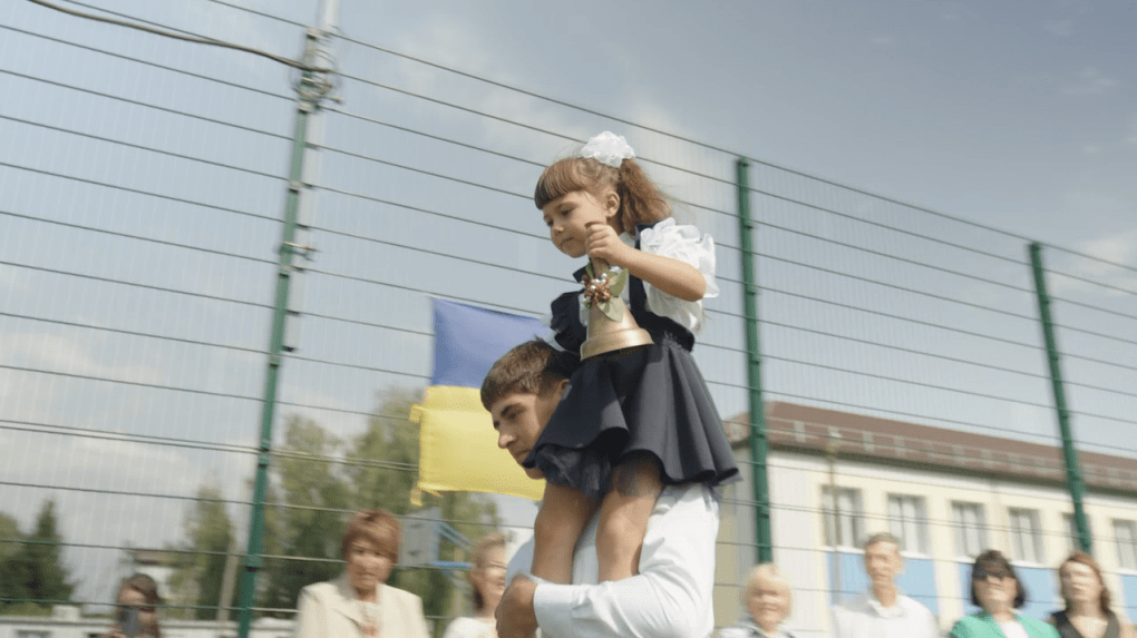 A first-grader rings the bell to mark the start of the school year at the Mykhailo-Kotsiubynsky Lyceum. Photo: UNITED24 Media