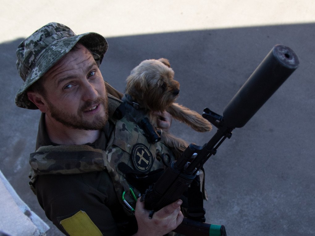Denys, a Priest from Pokrovsk and a sniper, known as the “Black Chaplain” with his dog Brulik (Source: Jessica Daly UNITED24 Media) Denys, a Priest from Pokrovsk and a sniper, known as the “Black Chaplain” with his dog Brulik (Source: Jessica Daly UNITED24 Media)
