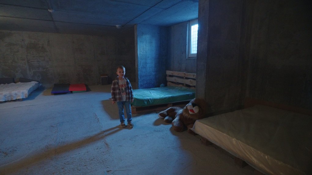 Robert shows a toy lion standing beside the beds in the shelter. (Source: Mykola Hrinenko/UNITED24 Media) Robert shows a toy lion standing beside the beds in the shelter. (Source: Mykola Hrinenko/UNITED24 Media)