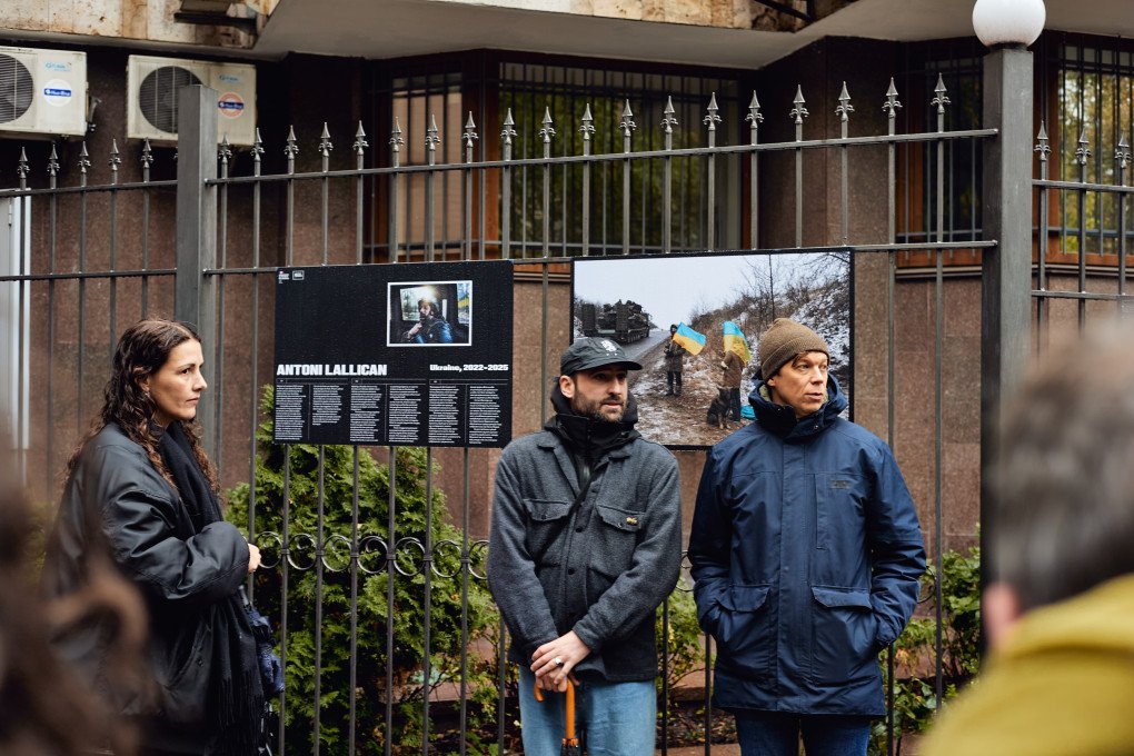 Aïda Belloulid, former partner of Antoni Lallican, French photographer Adrien Vautier, and curator Oleg Sosnov during the opening of Antoni Lallican’s exhibition on the gates of the French Embassy in Ukraine. Kyiv, Ukraine. October 2026. (Photo: Louis Beaudemont/UNITED24 Media)