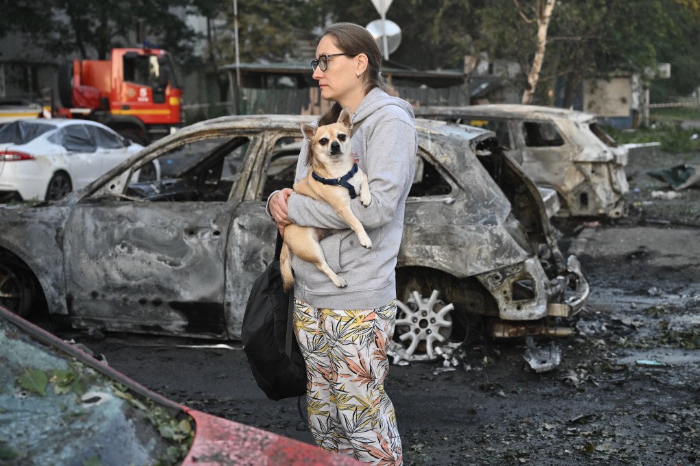 A resident holds her dog beside a damaged apartment building following a Russian ballistic missile strike in Kyiv on August 1, 2026. (Source: Getty Images) A resident holds her dog beside a damaged apartment building following a Russian ballistic missile strike in Kyiv on August 1, 2026. (Source: Getty Images)