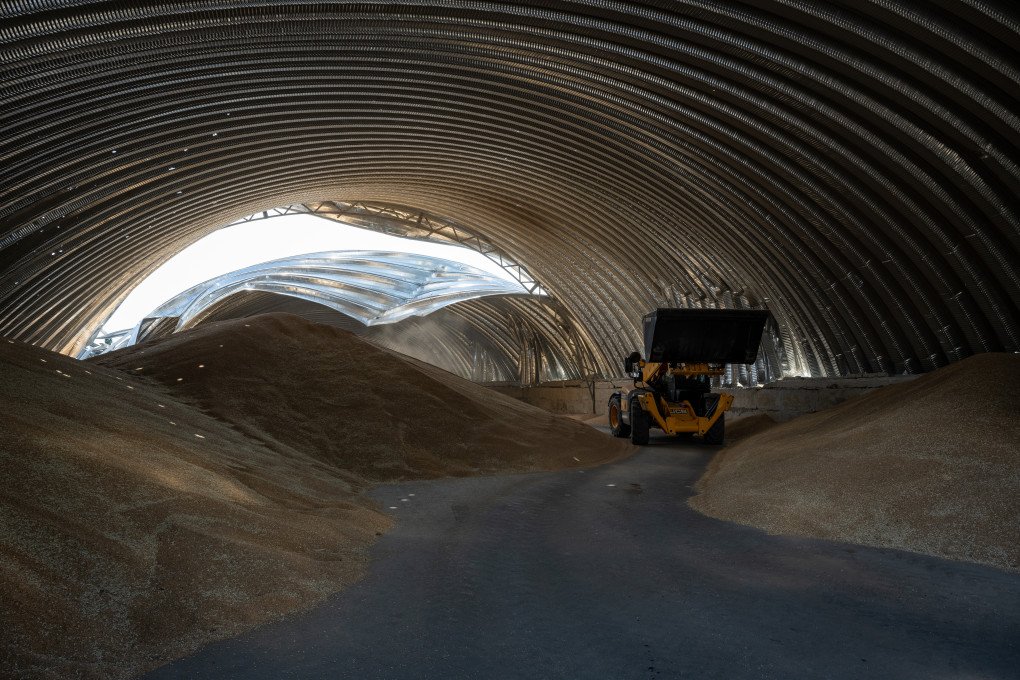 Sunlight coming through shrapnel holes in the roof dapples piles of barley, as Ukrainians salvage barley and peas three days after five Russian missiles struck a grain storage facility in the village of Pavlivka, Odesa region, Ukraine, on July 24, 2023. (Photo by Scott Peterson via Getty Images)