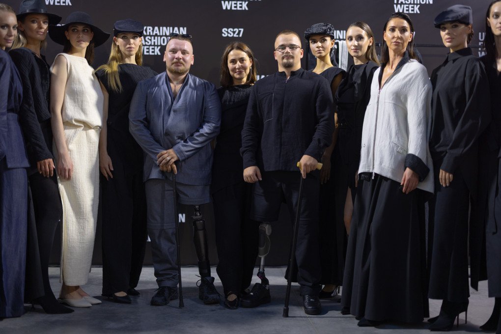 Two Ukrainian veterans join designer Yuliia Perekriostova and models following the JULIYA KROS SS2027 RECONSTRUCTION show during Ukrainian Fashion Week in Kyiv on September 4, 2026. (Source: Vic Bakin/UNITED24 Media)