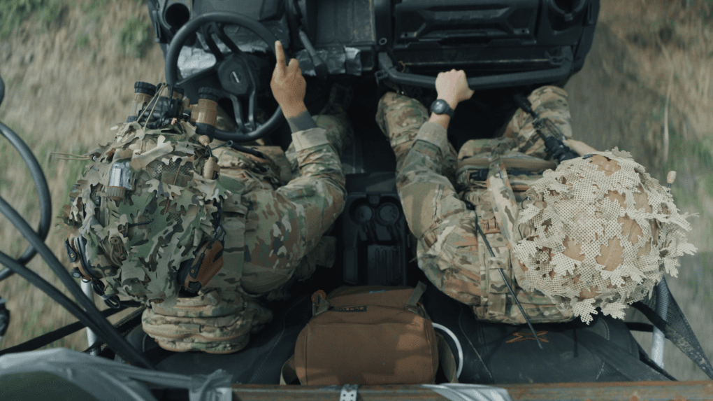 Two members of Ukraine’s elite medical unit Snake ride in a tactical vehicle across open terrain, navigating toward the front lines to evacuate the wounded under fire. Two members of Ukraine’s elite medical unit Snake ride in a tactical vehicle across open terrain, navigating toward the front lines to evacuate the wounded under fire.