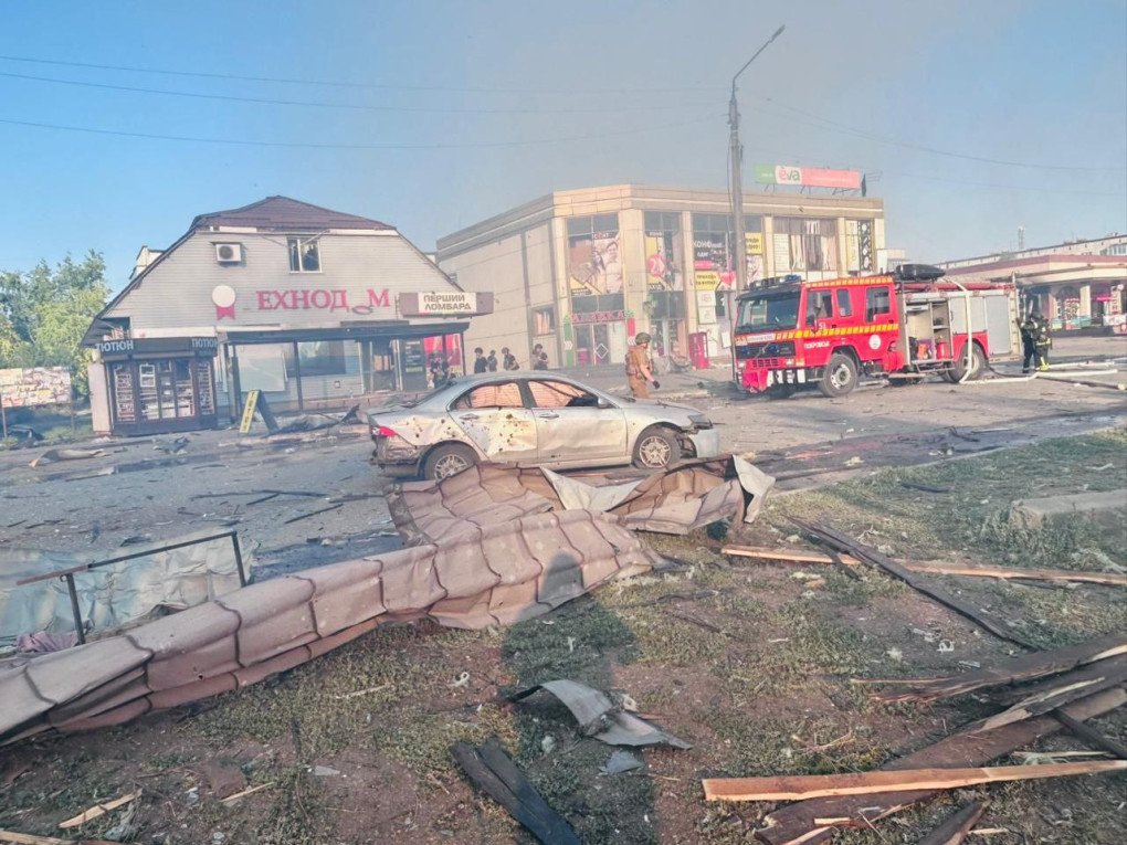 Debris strewn across the forecourt of a central Dobropillia shopping center after a 500-kg Russian airstrike on July 16, 2025, with damaged storefronts and vehicles in the background as rescue teams begin clearing operations. (Source: Vadym Filashkin/Telegram). Debris strewn across the forecourt of a central Dobropillia shopping center after a 500-kg Russian airstrike on July 16, 2025, with damaged storefronts and vehicles in the background as rescue teams begin clearing operations. (Source: Vadym Filashkin/Telegram).