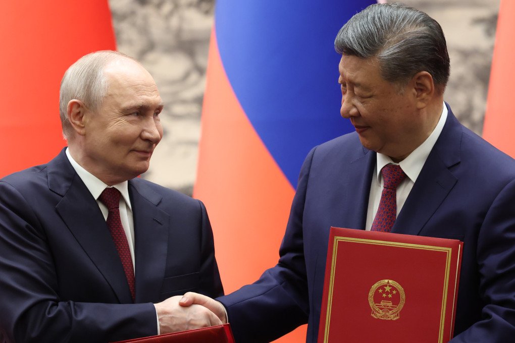 Russian leader Vladimir Putin and Chinese leader Xi Jinping shake hands during a signing ceremony at the Great Hall of the People on May 20, 2026 in Beijing, China. (Photo: Maxim Shemetov via Getty Images)