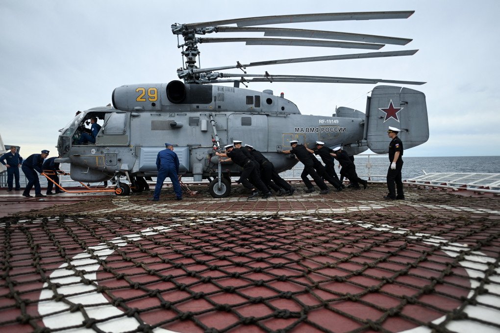 Russian sailors move a Russian Ka-27PL military helicopter on the deck of the Marshal Shaposhnikov anti-submarine destroyer during the “Vostok-2022” military exercises at the Peter the Great Gulf of the Sea of Japan outside the city of Vladivostok on September 5, 2022. (Source: Getty Images)