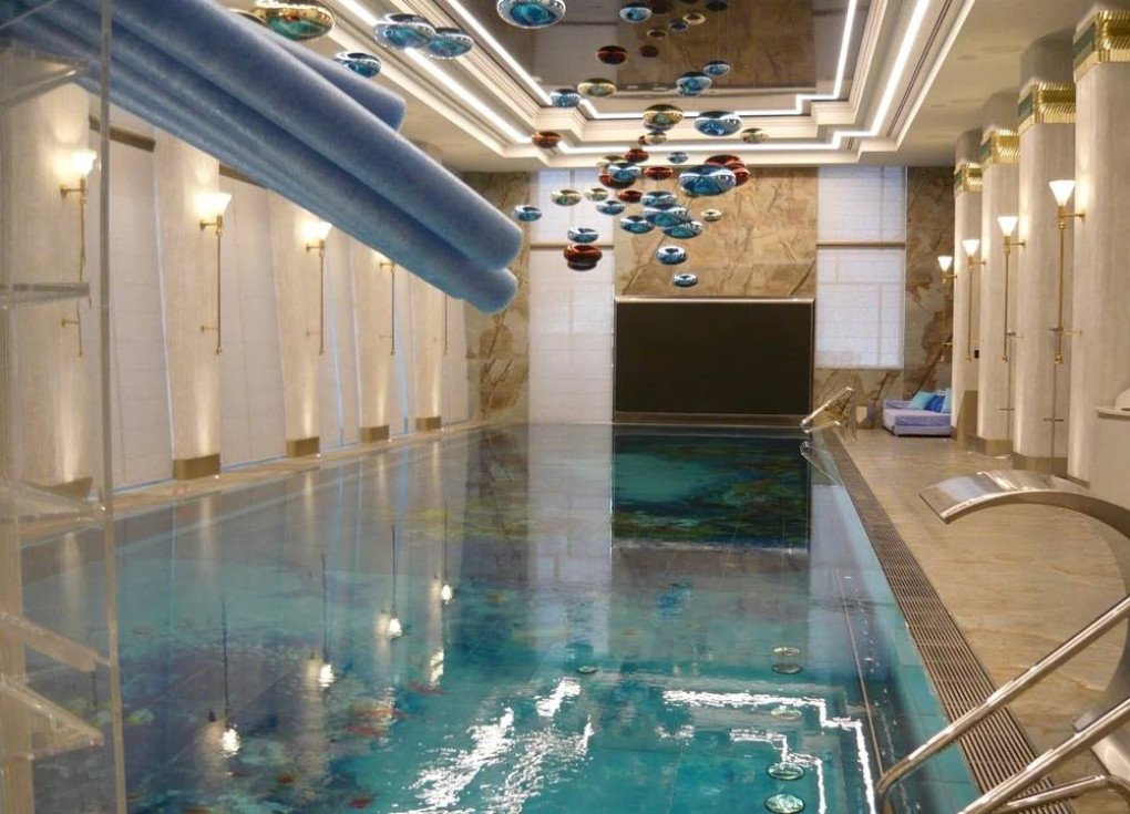 A lavish indoor swimming pool with artistic lighting features is part of the extensive spa wing within the $127 million complex. (Source: FBK)