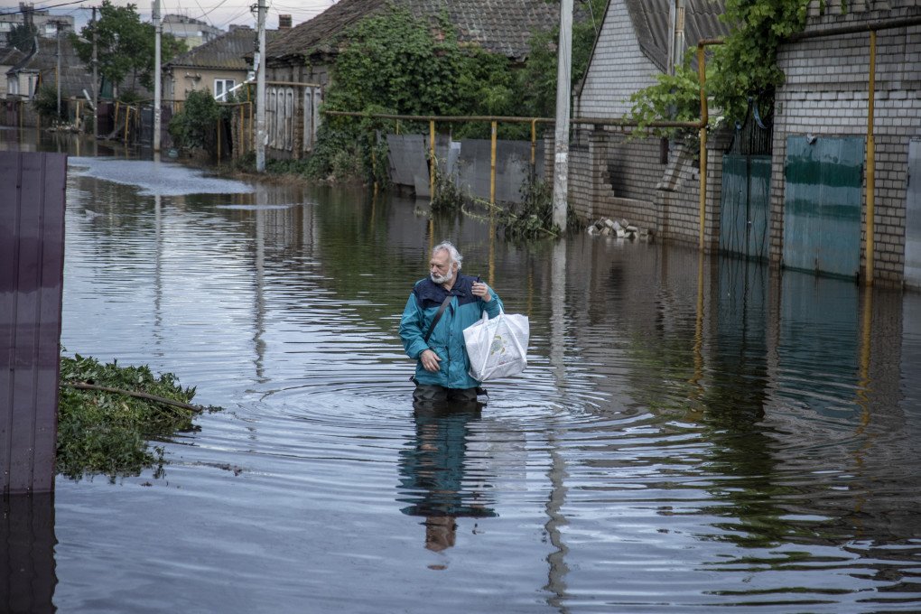 A local resident walks in a flooded street after the explosion at the Kakhovka hydropower plant unleashed floodwaters in Kherson, Ukraine on June 11, 2023. (Source: Narciso Contreras via Getty Images)
