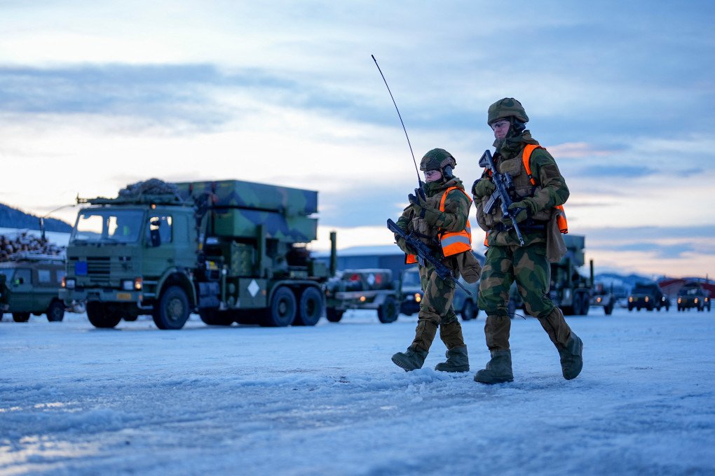 Norwegian soldiers walk past vehicles as military equipment is made ready to be loaded onto a ship at Orkanger Harbor, Norway. (Photo by Ole Martin via Getty Images) Norwegian soldiers walk past vehicles as military equipment is made ready to be loaded onto a ship at Orkanger Harbor, Norway. (Photo by Ole Martin via Getty Images)