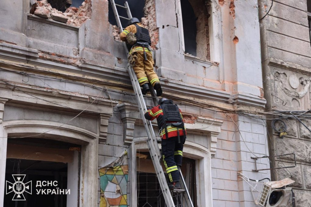 Firefighters climb ladders to access upper floors of the damaged kindergarten building during rescue operations in Kharkiv. (Source: Ukrainian President Volodymyr Zelenskyy)
