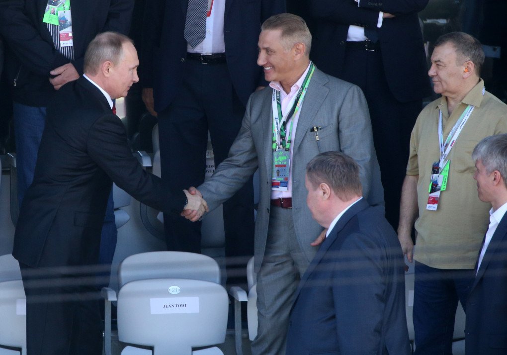 Russian President Vladimir Putin (L) shakes hands with billionaire and businessman Boris Rotenberg (C) and his brother, biilionaire Boris Rotenberg (R) looks on during the awarding ceremony at the 2017 Formuila 1 Russian Grand Prix in Sochi, Russia. (Photo by Mikhail Svetlov via Getty Images)