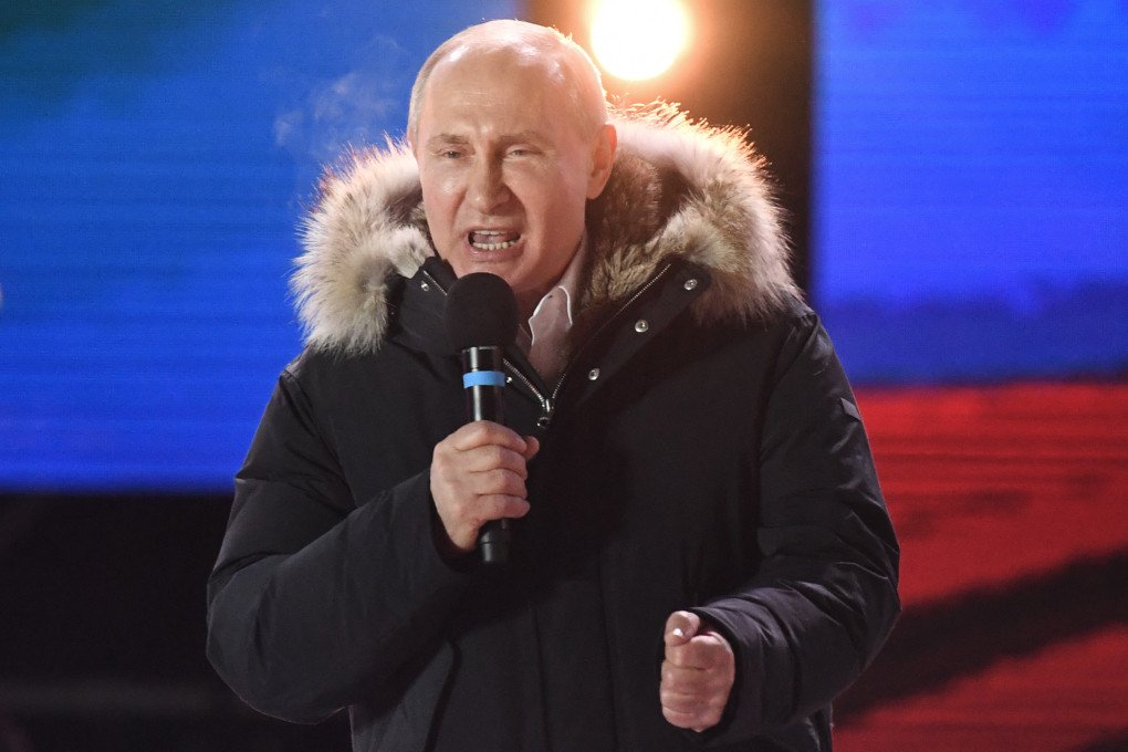 Russian leader Vladimir Putin addresses the crowd during a rally and a concert celebrating the fourth anniversary of Russia's annexation of Crimea at Manezhnaya Square in Moscow on March 18, 2018. (Photo by Kirill Kudryavtsev via Getty Images)