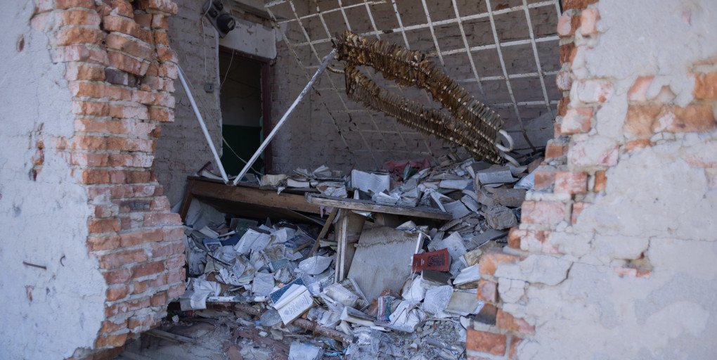 Notebooks and schoolbooks lie scattered across the floor of a destroyed library in Hrakove. (Photo: Vic Bakin/UNITED24 Media) Notebooks and schoolbooks lie scattered across the floor of a destroyed library in Hrakove. (Photo: Vic Bakin/UNITED24 Media)