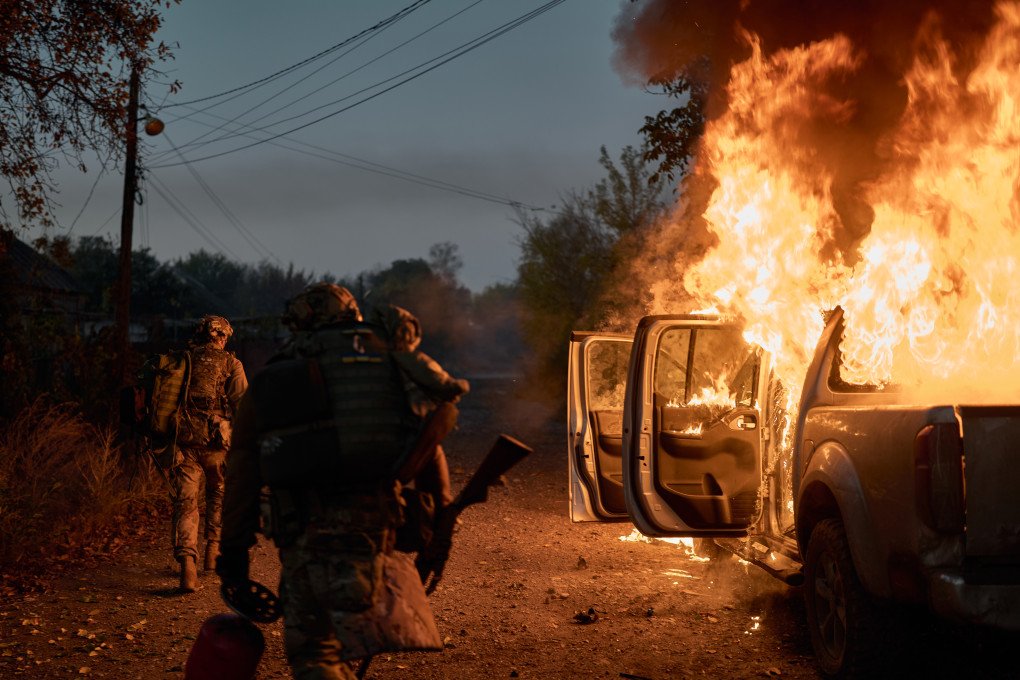 Ukrainian soldiers inspect a vehicle struck by a Russian FPV suicide drone near the frontline on October 16, 2025. Kostiantynivka, once a bustling city, now lies in ruins after months of intense Russian bombardments, with destroyed buildings, empty streets, and remnants of both military and civilian life. (Photo: Kostiantyn Liberov/Libkos/Getty Images) Kostiantynivka / Russian FPV suicide drone