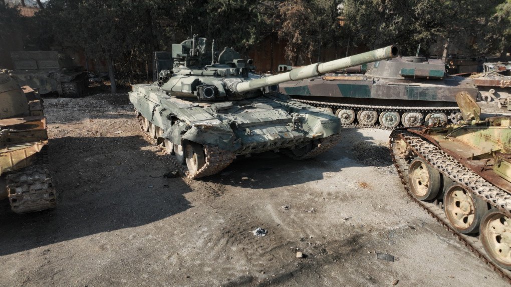 One of Russia’s most advanced tanks, the T-90A, sits with armored vehicles that were seized from the Assad regime by opposition forces in Idlib, Syria, on November 27, 2025. (Source: Getty Images)