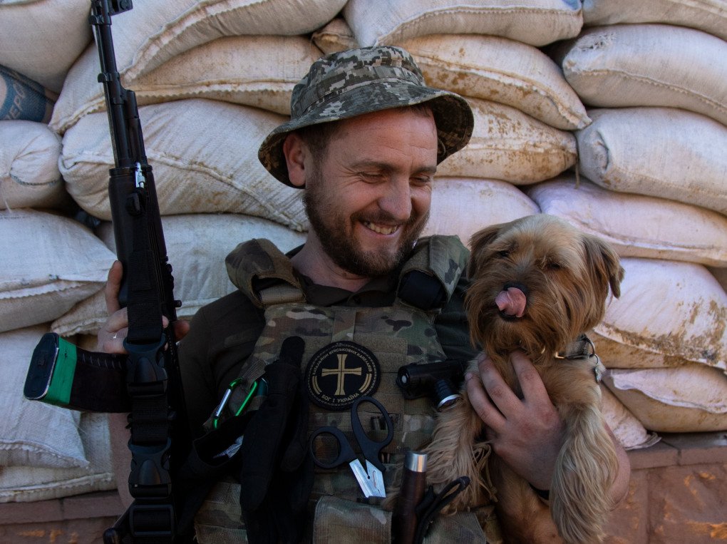Denys, a Priest from Pokrovsk and a sniper, known as the “Black Chaplain” with his dog Brulik (Source: Jessica Daly UNITED24 Media) Denys, a Priest from Pokrovsk and a sniper, known as the “Black Chaplain” with his dog Brulik (Source: Jessica Daly UNITED24 Media)