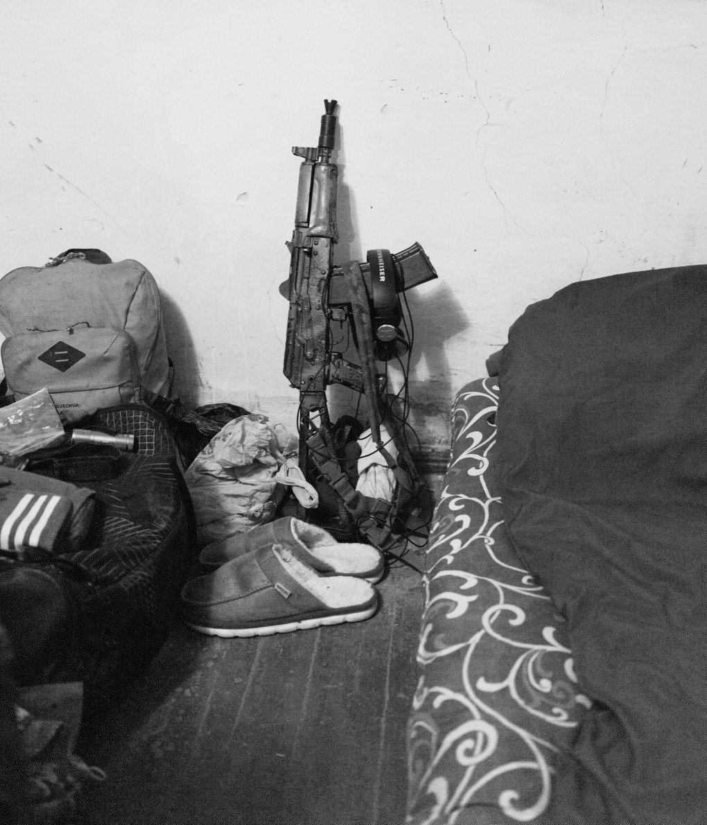 Headphones rest on a soldier’s weapon beside the bed. Headphones rest on a soldier’s weapon beside the bed.
