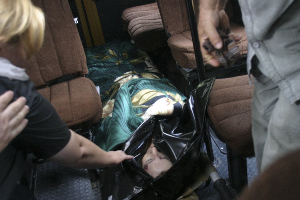 People look at a bullet hole in the face of slain Russian human rights activist Natalya Estemirova. (Source: Murad Musayev via Getty Images)