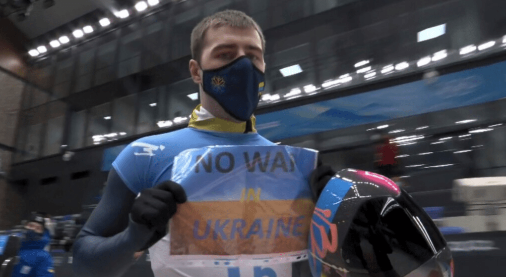 Vladyslav Heraskevych, Ukrainian skeleton athlete, holds up a “No War in Ukraine” sign during the 2022 Winter Olympics. (Source: Radio Liberty)