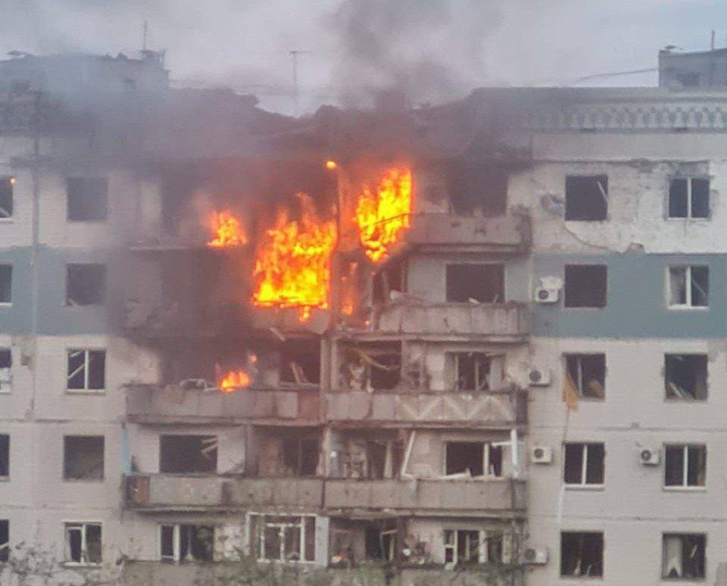 Flames and thick black smoke billow from a heavily damaged multi-story apartment block after a reported strike. (Photo: open source).