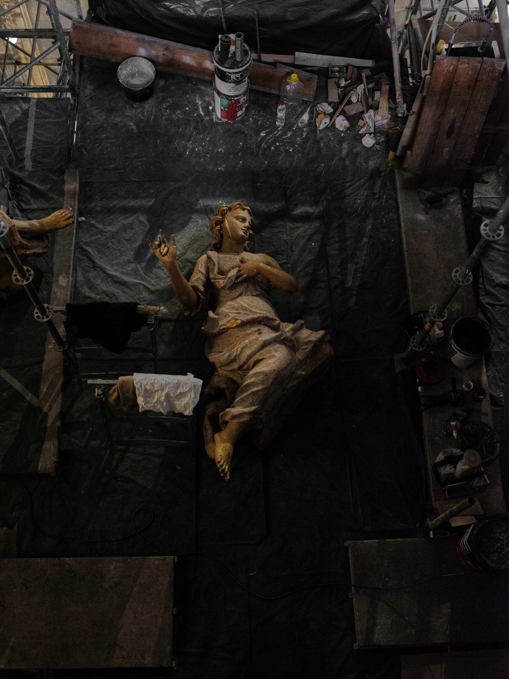 A larger-than-life gilded angel lies in restoration. A larger-than-life gilded angel lies in restoration.